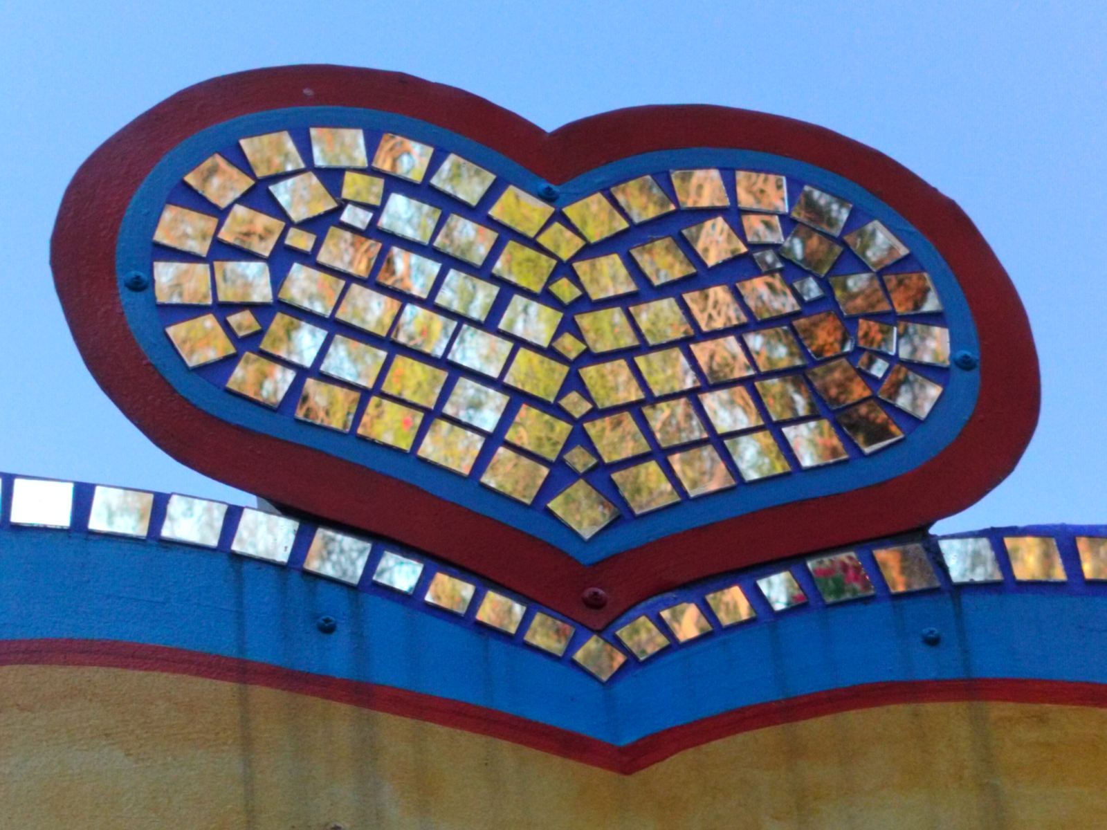 Mirror mosaic heart — iridescent tile art in red and blue
